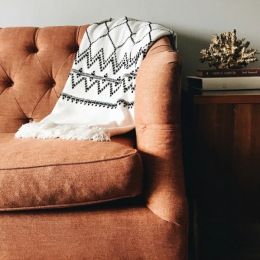 King’s Reserve Sterling offers 55+ residences designed for comfort, connection, and effortless living. ✨ Detail of a couch in a living room at King's Reserve Sterling apartments in Sterling, VA, featuring a coffee table.