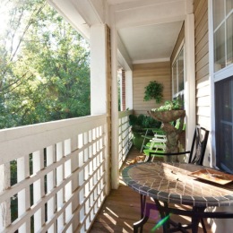 Embrace the longer days and revel in the soft breezes of spring from your balcony or patio at King's Reserve Sterling. ?️ Outdoor balcony at King's Reserve Sterling apartments in Sterling, VA, featuring sunlight and a view of trees.
