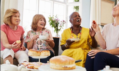 a group of women eating and smiling