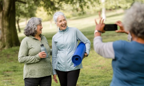 three people in a park taking a picture