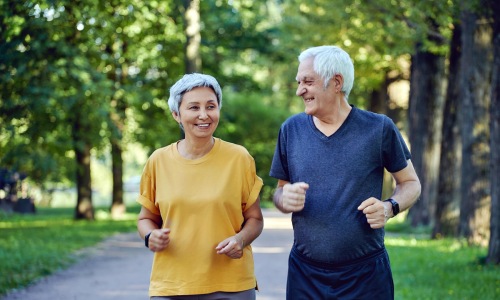 two people jogging on a path